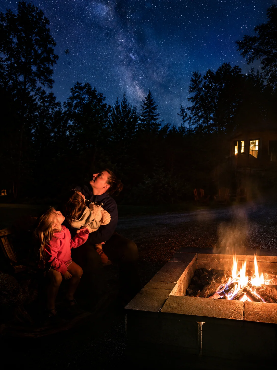 Family by the fire pit looking up at the night sky